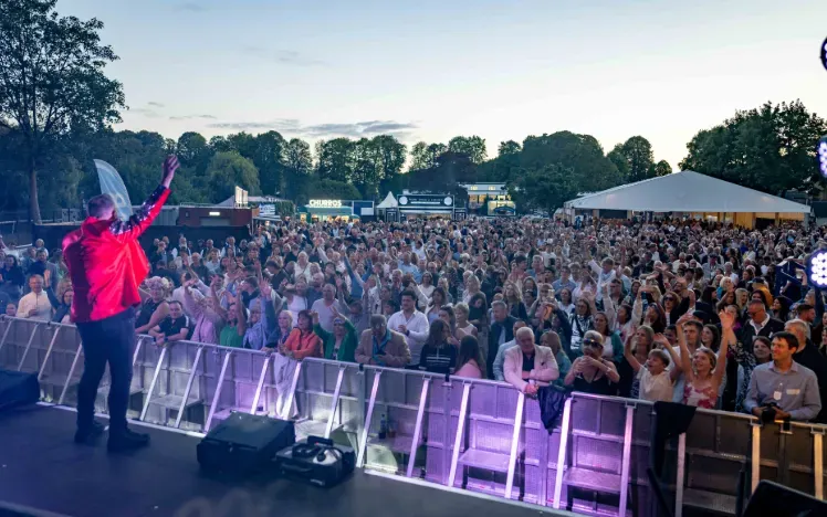 The view from the music stage at Windsor looking out at the dancing crowd at sunset
